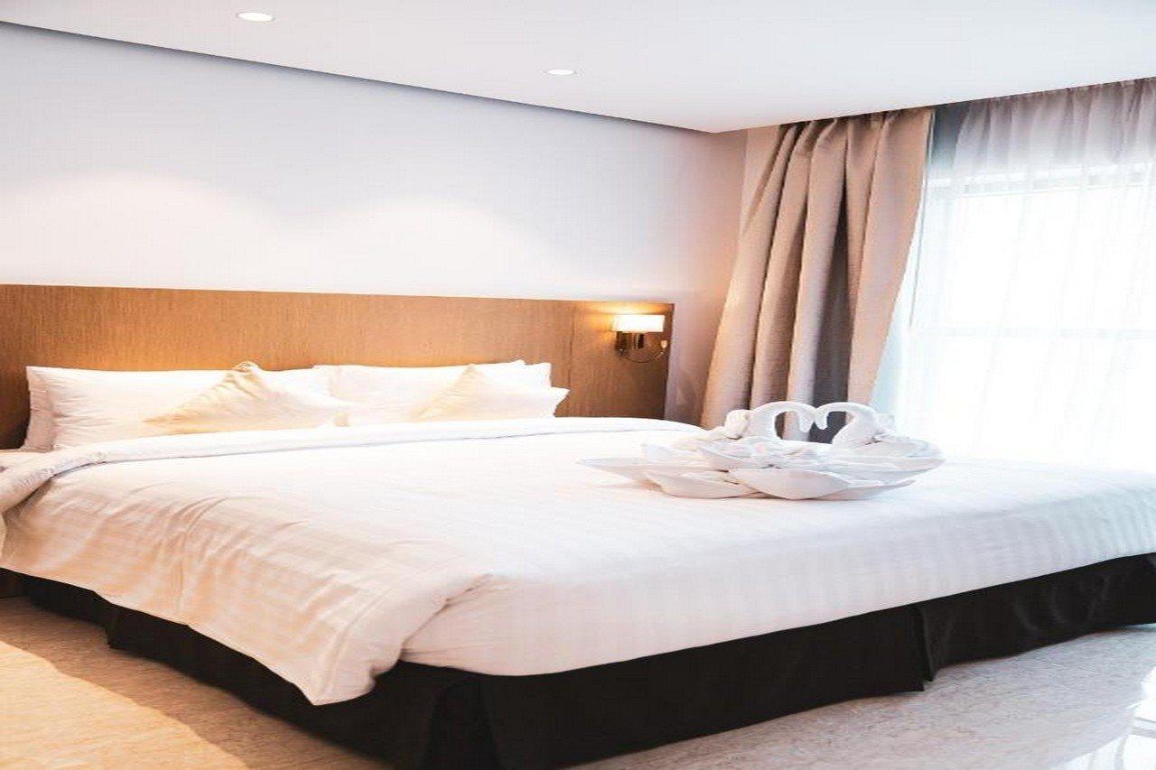 HE Hotel Apartments Dubai Exterior foto A bed